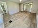 Open main bedroom with wood-look flooring, mirrored closet doors, and ensuite bathroom for added privacy at 504 Hawthorne Blvd, Leesburg, FL 34748