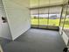 Enclosed screened in porch with carpeted flooring provides additional outdoor living space at 504 Hawthorne Blvd, Leesburg, FL 34748
