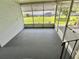Enclosed screened in porch with carpeted flooring provides additional outdoor living space at 504 Hawthorne Blvd, Leesburg, FL 34748