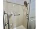 Updated tiled shower includes built-in shelving and safety grab bar at 504 Hawthorne Blvd, Leesburg, FL 34748