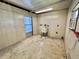 Large utility room with a slop sink and a window air conditioner allows for multiple uses at 504 Hawthorne Blvd, Leesburg, FL 34748