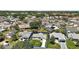 Aerial view of property showcasing the home's location in a neighborhood with mature trees and well-kept homes at 517 San Pedro Dr, Lady Lake, FL 32159