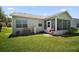 Inviting backyard with a screened patio, well-maintained lawn, and mature greenery, creating a cozy and private outdoor space at 517 San Pedro Dr, Lady Lake, FL 32159
