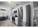 Modern kitchen featuring stainless steel appliances, white cabinets, and an adjacent breakfast nook at 517 San Pedro Dr, Lady Lake, FL 32159