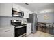 Modern kitchen featuring stainless steel appliances and white cabinetry at 517 San Pedro Dr, Lady Lake, FL 32159