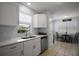 Contemporary kitchen featuring white countertops and cabinets, stainless steel appliances, and a breakfast nook nearby at 517 San Pedro Dr, Lady Lake, FL 32159