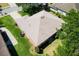 Aerial of home featuring a light brown roof and lush landscaping surrounding the property at 5209 Grove Mnr, Lady Lake, FL 32159