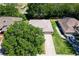 Aerial view showing the home's proximity to mature trees and the surrounding neighborhood at 5209 Grove Mnr, Lady Lake, FL 32159