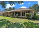 Well-maintained home exterior showcasing a neatly manicured lawn and beautiful landscaping at 5209 Grove Mnr, Lady Lake, FL 32159