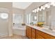 Well-lit bathroom showcasing dual sinks, a separate shower, and a relaxing tub at 5209 Grove Mnr, Lady Lake, FL 32159