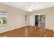 Light-filled bedroom featuring hardwood floors, slider to porch, and large windows at 5209 Grove Mnr, Lady Lake, FL 32159