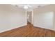 Spacious bedroom with hardwood floors and neutral paint, ready for your personal touch at 5209 Grove Mnr, Lady Lake, FL 32159