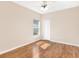 A sunny bedroom featuring vinyl floors, a ceiling fan, and a large window at 5209 Grove Mnr, Lady Lake, FL 32159