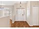 Inviting foyer with hardwood floors, a large front door, and abundant natural light at 5209 Grove Mnr, Lady Lake, FL 32159
