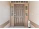 Welcoming front door with sidelights and decor creating a cozy entrance at 5209 Grove Mnr, Lady Lake, FL 32159