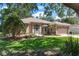 Charming single-story home with landscaped front yard and an attached two-car garage at 5209 Grove Mnr, Lady Lake, FL 32159