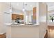 Well-appointed kitchen with white countertops, stainless steel appliances, and breakfast bar at 5209 Grove Mnr, Lady Lake, FL 32159