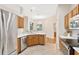 Modern kitchen featuring white counters, stainless appliances, wooden cabinetry, and tile floors at 5209 Grove Mnr, Lady Lake, FL 32159