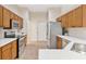 Contemporary kitchen design with stainless steel appliances and wood cabinets, offers lots of counter space at 5209 Grove Mnr, Lady Lake, FL 32159