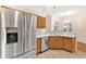 Bright kitchen featuring stainless steel appliances, wood cabinets, and a spacious countertop at 5209 Grove Mnr, Lady Lake, FL 32159