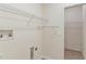Well-organized laundry room with shelving for ample storage at 5209 Grove Mnr, Lady Lake, FL 32159