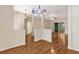 Bright living room featuring hardwood floors, modern lighting, and view to enclosed patio at 5209 Grove Mnr, Lady Lake, FL 32159