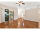 Open living room featuring hardwood floors, modern lighting, and a sliding glass door at 5209 Grove Mnr, Lady Lake, FL 32159