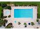 Aerial view of a large rectangular community pool with many lounge chairs at 5209 Grove Mnr, Lady Lake, FL 32159