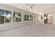 Bright sunroom with large windows, ceiling fans, and access to the backyard at 5209 Grove Mnr, Lady Lake, FL 32159