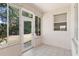 Bright sunroom features tile flooring, and sliding glass doors open to a serene backyard at 5209 Grove Mnr, Lady Lake, FL 32159