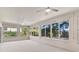 Spacious sunroom with large windows offering plenty of natural light and beautiful outdoor views at 5209 Grove Mnr, Lady Lake, FL 32159