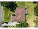 Birds eye view of home with lush greenery showcasing the roof and landscaping at 5306 Greens Dr, Lady Lake, FL 32159