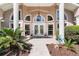 The double doors offer a grand entrance to this stately home at 5306 Greens Dr, Lady Lake, FL 32159