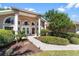 The front entrance of this home is bright and welcoming, framed by large columns at 5306 Greens Dr, Lady Lake, FL 32159
