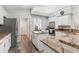 Well-lit kitchen with stainless steel appliances, granite countertops, and hardwood floors at 5306 Greens Dr, Lady Lake, FL 32159