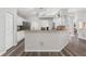 Open-concept kitchen with granite countertops and hardwood floors at 5306 Greens Dr, Lady Lake, FL 32159