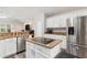 Open kitchen featuring stainless steel appliances, granite countertops, and hardwood floors at 5306 Greens Dr, Lady Lake, FL 32159