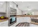 Bright kitchen with stainless steel appliances and granite countertops at 5306 Greens Dr, Lady Lake, FL 32159