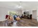 Cozy living room featuring hardwood floors and large windows at 5306 Greens Dr, Lady Lake, FL 32159