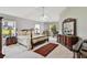 Spacious main bedroom boasts a four-poster bed, a ceiling fan, and bright windows at 5306 Greens Dr, Lady Lake, FL 32159