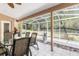 Relaxing screened-in patio with a dining table and chairs perfect for outdoor entertaining at 5306 Greens Dr, Lady Lake, FL 32159