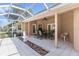 Spacious enclosed patio with a dining table, chairs, a ceiling fan and a fountain at 5306 Greens Dr, Lady Lake, FL 32159