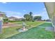 Expansive backyard with lush lawn, mature trees, and a charming birdbath focal point at 5433 County Road 125, Wildwood, FL 34785