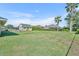 Vast backyard featuring a large lawn, utility shed, and mature trees offering shade and privacy at 5433 County Road 125, Wildwood, FL 34785