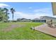 Expansive backyard with well-manicured lawn, mature trees, and outdoor patio for outdoor enjoyment at 5433 County Road 125, Wildwood, FL 34785