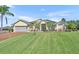 Charming single-story home with a lush green lawn and well-maintained landscaping at 5433 County Road 125, Wildwood, FL 34785