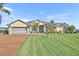 Inviting single-story home with a well-manicured lawn and a charming front entrance at 5433 County Road 125, Wildwood, FL 34785