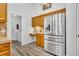 Kitchen showcasing stainless steel refrigerator and breakfast bar at 5433 County Road 125, Wildwood, FL 34785