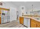 Bright kitchen with stainless steel appliances and breakfast bar area at 5433 County Road 125, Wildwood, FL 34785