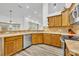 Bright kitchen features wood cabinets, stainless steel appliances, and tile countertops at 5433 County Road 125, Wildwood, FL 34785
